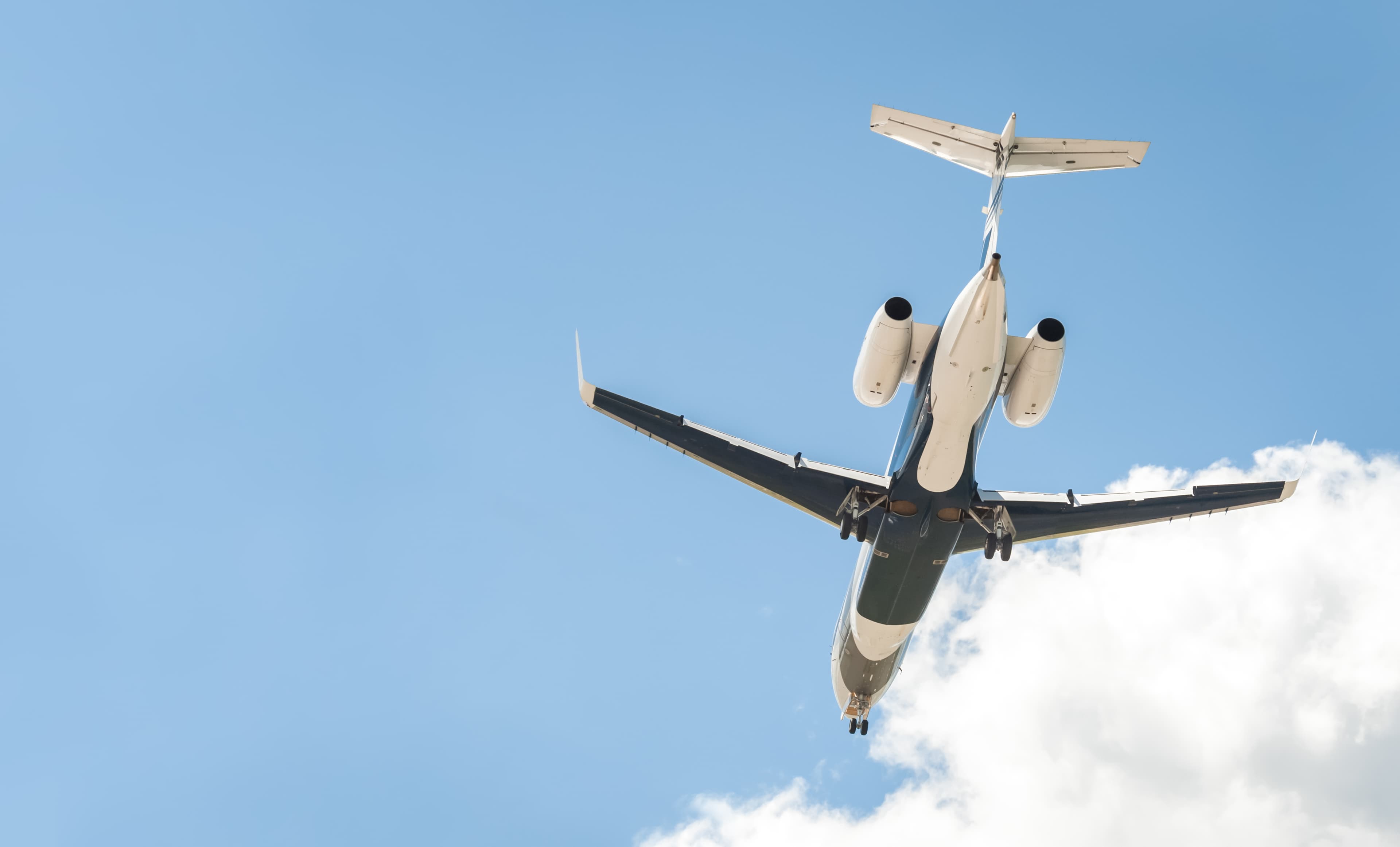 Jet flying in a blue, cloudy sky